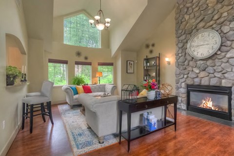 a living room with a stone fireplace and a couch